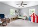 Cozy bedroom with a ceiling fan, two windows, and playful decor at 4904 Kessler Blvd N Dr, Indianapolis, IN 46228