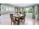 Bright dining room with a wood table, large windows and light, wood-look flooring at 4904 Kessler Blvd N Dr, Indianapolis, IN 46228
