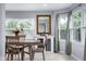 Charming dining room with a wooden table, a mirrored bar, and views of the outside at 4904 Kessler Blvd N Dr, Indianapolis, IN 46228