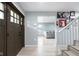 Welcoming foyer boasts hardwood floors, a staircase, and a view into the cozy living room at 4904 Kessler Blvd N Dr, Indianapolis, IN 46228
