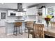 Open kitchen with white cabinets, stainless appliances, breakfast bar and adjoining dining area at 4904 Kessler Blvd N Dr, Indianapolis, IN 46228