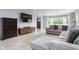 Comfortable living room with a large sectional sofa, modern media console, and a view of the front yard at 4904 Kessler Blvd N Dr, Indianapolis, IN 46228