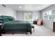 Bright bedroom featuring a cozy chair and a private entrance to the balcony at 4904 Kessler Blvd N Dr, Indianapolis, IN 46228