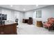 Home office space with natural light, a built-in desk, and comfortable seating at 4904 Kessler Blvd N Dr, Indianapolis, IN 46228