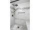 Modern shower featuring designer tile, a rain showerhead, and built-in shelving at 4904 Kessler Blvd N Dr, Indianapolis, IN 46228