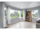 Sun-drenched room with bright windows, hardwood floors, and a bookshelf at 4904 Kessler Blvd N Dr, Indianapolis, IN 46228
