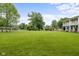 Expansive front yard featuring a lush green lawn and mature trees, providing ample space at 4904 Kessler Blvd N Dr, Indianapolis, IN 46228