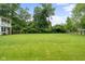 Large grassy backyard with mature trees, perfect for outdoor activities and relaxation at 4904 Kessler Blvd N Dr, Indianapolis, IN 46228