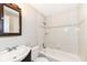 Tiled bathroom with vanity, mirror, toilet and shower-tub combo with patterned accent tiles at 5141 Annette St, Indianapolis, IN 46208
