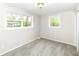 Bright bedroom with plush carpet, neutral walls, and ample windows for natural light and ventilation at 5141 Annette St, Indianapolis, IN 46208