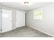 Bedroom boasts neutral walls, plush carpeting, a window for light, and a built-in closet at 5141 Annette St, Indianapolis, IN 46208