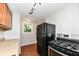 Kitchen features granite counters, oak cabinets, and black refrigerator for food storage and meal preparation at 5141 Annette St, Indianapolis, IN 46208