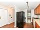 A functional kitchen with black refrigerator and view to the adjacent room for easy access at 5141 Annette St, Indianapolis, IN 46208