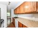 Kitchen featuring granite counters, stainless steel sink, and oak cabinets for cooking and food preparation at 5141 Annette St, Indianapolis, IN 46208