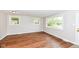 Sunlit living room with wood-look flooring, large windows, and neutral paint colors throughout at 5141 Annette St, Indianapolis, IN 46208