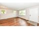 Bright living room with wood-look flooring, neutral walls, and large windows at 5141 Annette St, Indianapolis, IN 46208