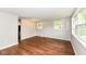 Bright living room featuring wood-look floors, neutral paint, and multiple windows at 5141 Annette St, Indianapolis, IN 46208