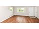 Inviting living room featuring wood-look flooring, neutral walls, and ample natural light at 5141 Annette St, Indianapolis, IN 46208