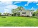 Beautiful backyard with a lush lawn, mature trees, and a screened porch of this inviting home at 5341 Armstrong Dr, Indianapolis, IN 46237