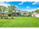 Spacious backyard boasts a lush lawn, well-maintained landscaping, and a charming screened-in porch at 5341 Armstrong Dr, Indianapolis, IN 46237