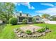 Expansive backyard features a screened-in porch, manicured lawn, a stone patio, and lush landscaping at 5341 Armstrong Dr, Indianapolis, IN 46237