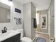 A bathroom featuring a toilet, sink, mirror, and shiplap accent wall at 5341 Armstrong Dr, Indianapolis, IN 46237