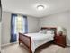 A bedroom with wooden bed frame, window, and a nightstand at 5341 Armstrong Dr, Indianapolis, IN 46237