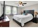 Bedroom with a bed, dark wood furniture, and a ceiling fan with lighting at 5341 Armstrong Dr, Indianapolis, IN 46237