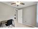 Bright bedroom boasts neutral walls, carpet, a desk, ceiling fan, and an open doorway to the main bedroom at 5341 Armstrong Dr, Indianapolis, IN 46237