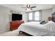 Bedroom with a bed, dresser with TV, and windows with decorative curtains at 5341 Armstrong Dr, Indianapolis, IN 46237