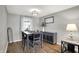 Dining room with modern light fixture, table with seating for four, and stylish sideboard at 5341 Armstrong Dr, Indianapolis, IN 46237