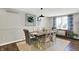 Dining area features stylish table and chairs, with elegant wainscoting and bright natural light, perfect for hosting meals at 5341 Armstrong Dr, Indianapolis, IN 46237