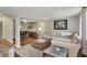 Open-concept living room with a large sectional couch and view into the dining room at 5341 Armstrong Dr, Indianapolis, IN 46237