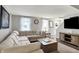Comfortable living room with neutral tones, large sectional sofa, and view of the foyer at 5341 Armstrong Dr, Indianapolis, IN 46237