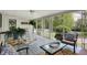 Charming sunroom with rocking chairs, potted plants, and scenic views at 5341 Armstrong Dr, Indianapolis, IN 46237
