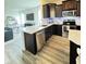 Well-lit kitchen featuring stainless appliances, granite countertops, and dark cabinets at , McCordsville, IN 46055