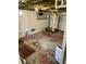 View of the basement, with painted walls and ceiling utility hook ups at 5841 E Julian Ave, Indianapolis, IN 46219