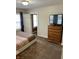 Bedroom with plush carpet, dresser with TV, and adjoining room, creating a relaxing retreat at 5841 E Julian Ave, Indianapolis, IN 46219