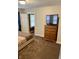Bedroom with plush carpet, dresser with TV, and adjoining room, creating a relaxing retreat at 5841 E Julian Ave, Indianapolis, IN 46219
