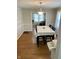 Dining room featuring hardwood floors, a large table with seating, and decorative wall accents at 5841 E Julian Ave, Indianapolis, IN 46219