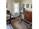 Bright exercise room with natural light, complete with treadmill, free weights and workout bench at 5841 E Julian Ave, Indianapolis, IN 46219