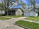 Charming house with stone and siding, a detached garage, and a mature tree at 5841 E Julian Ave, Indianapolis, IN 46219
