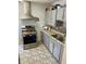 Modern kitchen equipped with stainless steel appliances, stylish countertops, and gray cabinets at 5841 E Julian Ave, Indianapolis, IN 46219