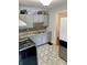 Quaint kitchen boasting gray cabinetry, updated countertops, stainless steel appliances, and patterned tile flooring at 5841 E Julian Ave, Indianapolis, IN 46219