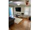 Cozy living room with hardwood floors, a comfortable sofa, and a large entertainment center at 5841 E Julian Ave, Indianapolis, IN 46219