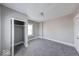Cozy bedroom featuring neutral paint, plush carpeting, a window, and a closet at 623 Arbor Ave, Indianapolis, IN 46221