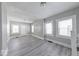 Well-lit living room featuring gray walls, white trim, modern flooring, and multiple windows for abundant light at 623 Arbor Ave, Indianapolis, IN 46221