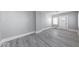 Clean and bright living room featuring sleek floors, fresh paint, and well-placed electrical outlets at 623 Arbor Ave, Indianapolis, IN 46221