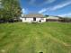 A large, green, fenced-in backyard providing space for outdoor enjoyment and activities, with a wooden deck at 6231 Oak Limb Ct, Indianapolis, IN 46221