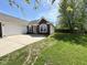 Charming front exterior with a two-car garage, well-manicured lawn, and inviting curb appeal, offering a warm welcome at 6231 Oak Limb Ct, Indianapolis, IN 46221